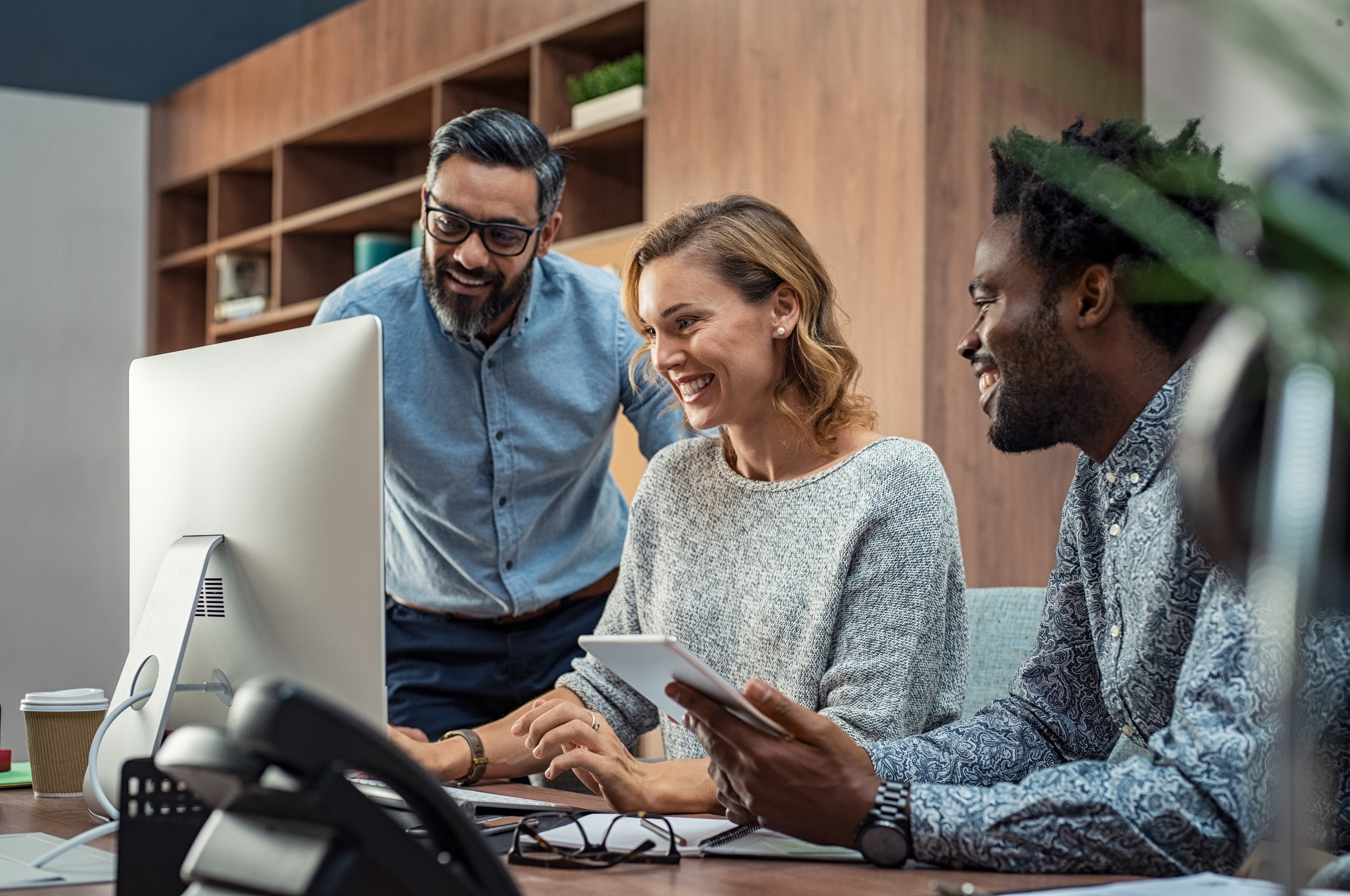 team gathered around a computer
